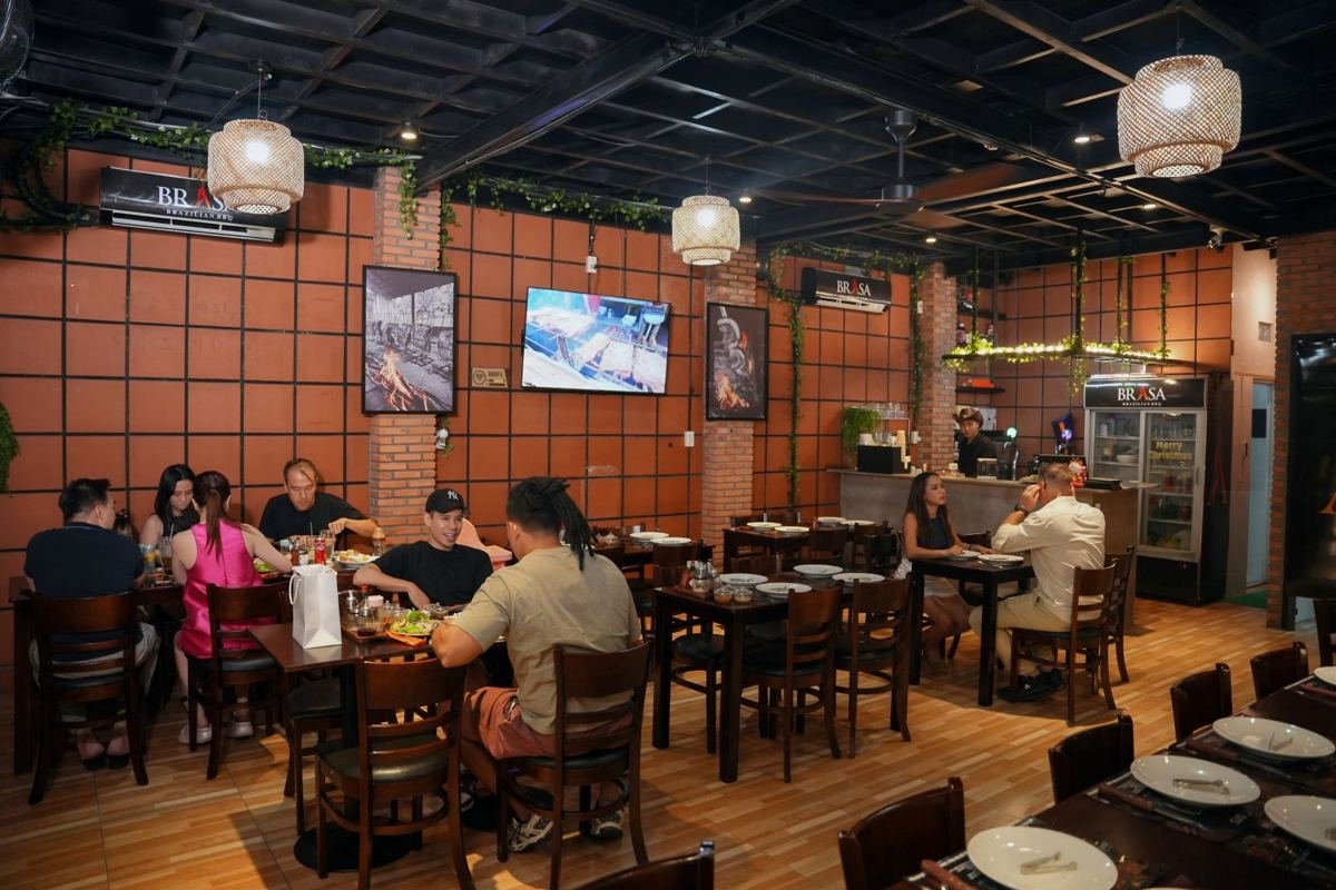 The dining room at Brasa Brazilian restaurant in An Khánh, Thủ Đức, with guests at the tables