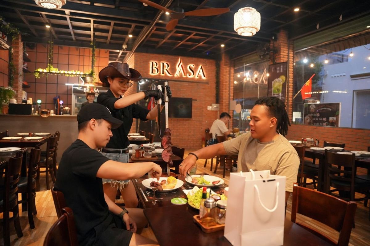 Guests enjoying rodízio at their table at Brasa Brazilian restaurant
